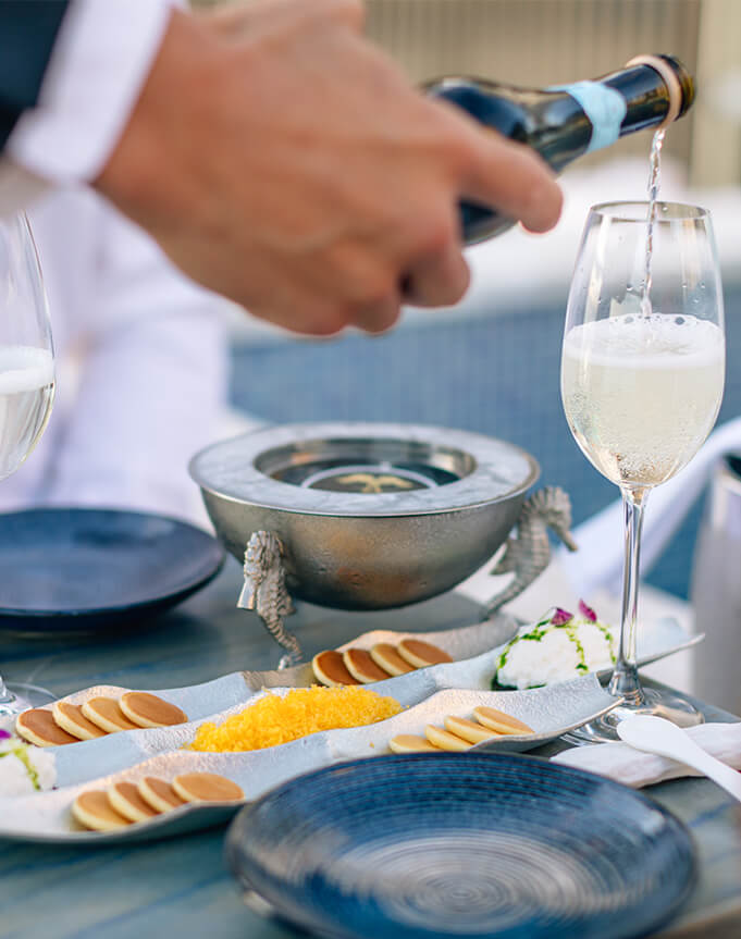 Champagne pouring and caviar setting.