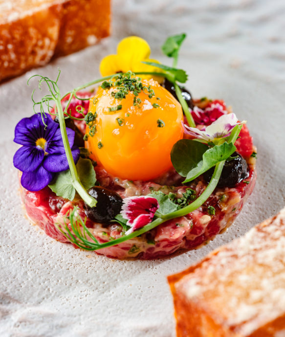 Wagyu Tartare with egg and edible flowers